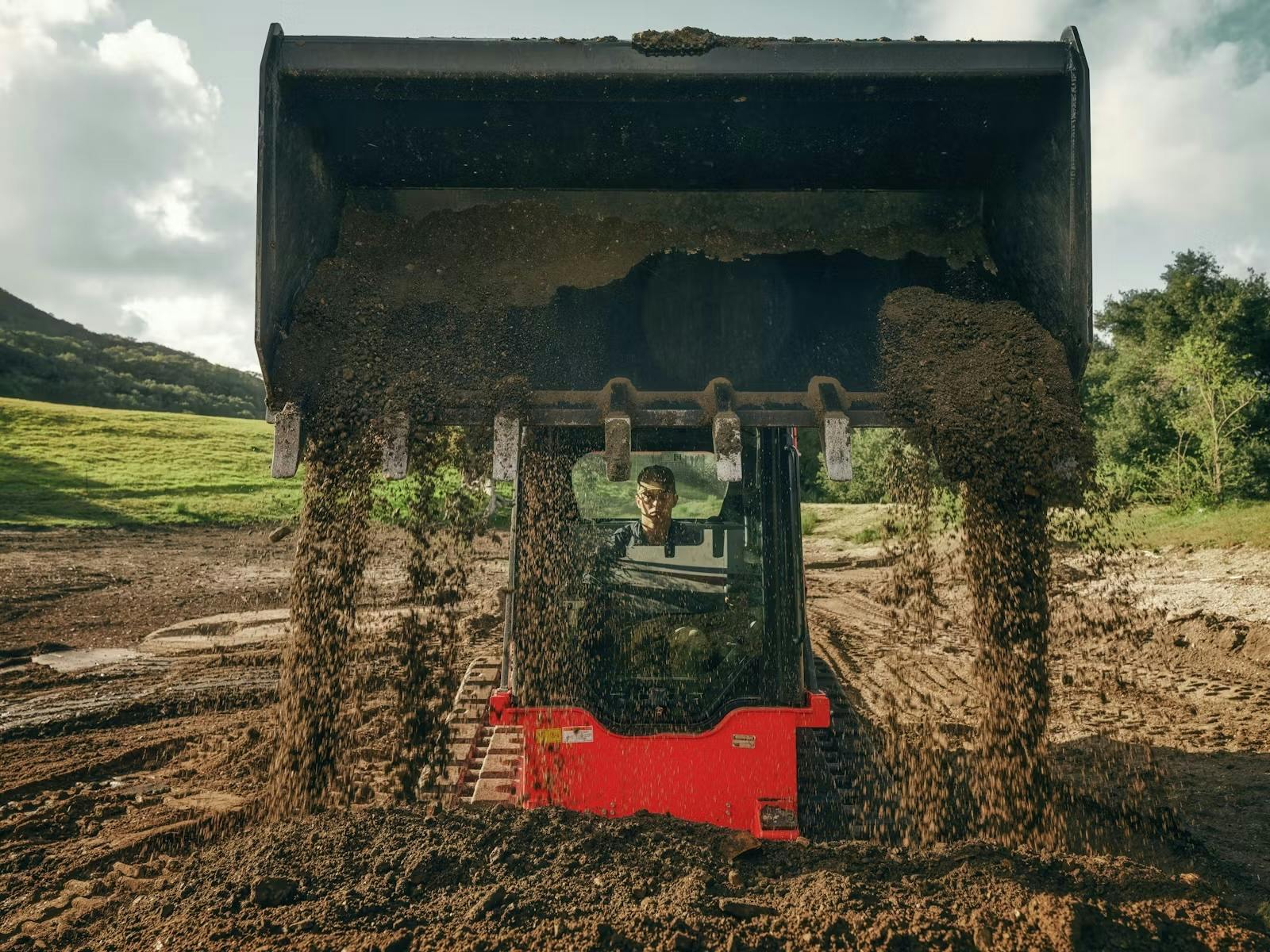 Kioti CTL close dumping dirt