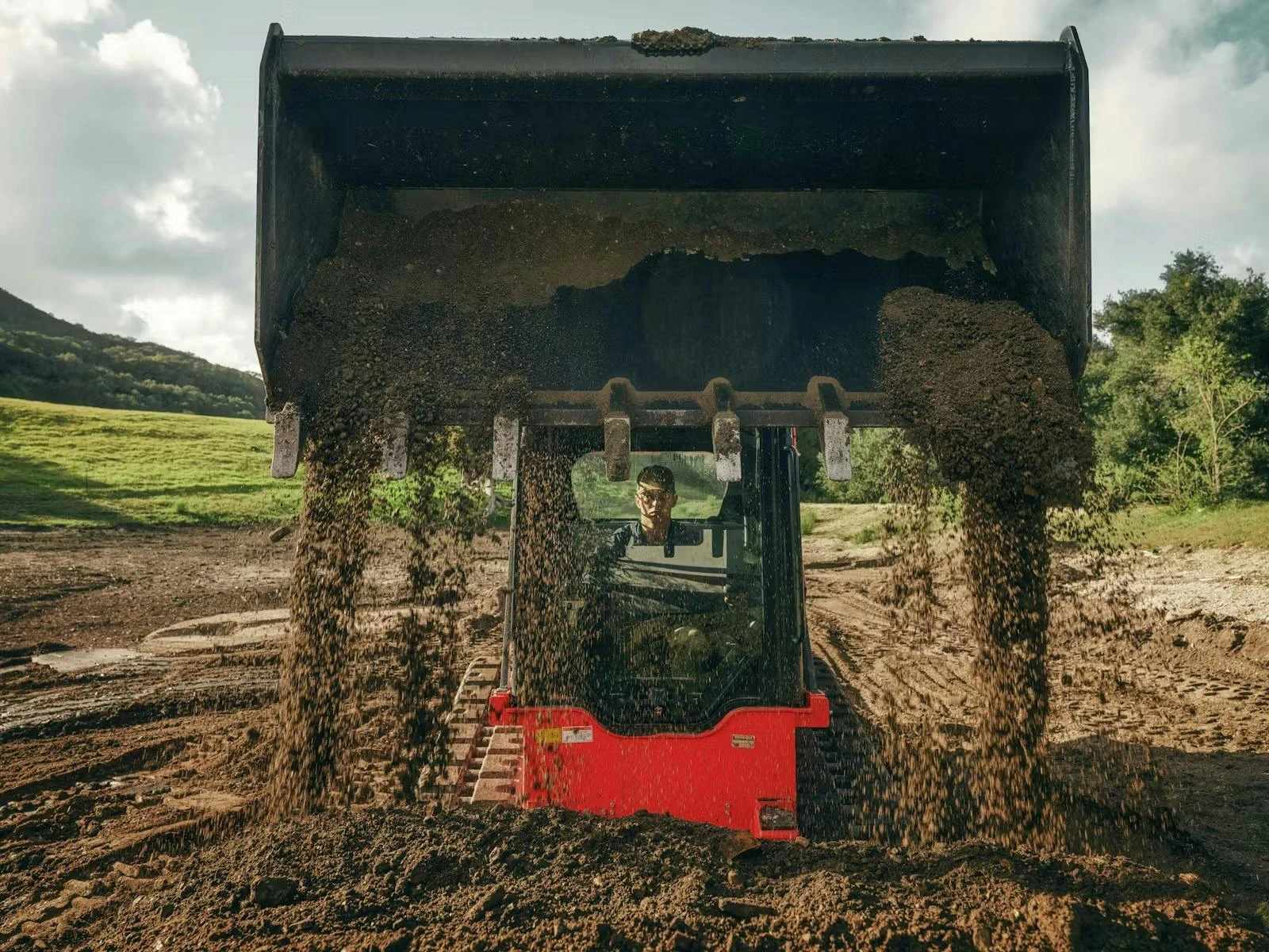 Kioti CTL close dumping dirt