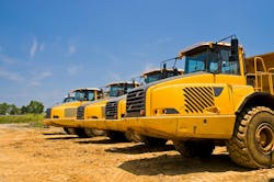Articulated dump trucks lined up in a yard Articulated dump trucks lined up in a yard