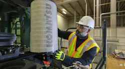 Komatsu wheel loader with a mechanic taking out the filter Komatsu wheel loader with a mechanic taking out the filter