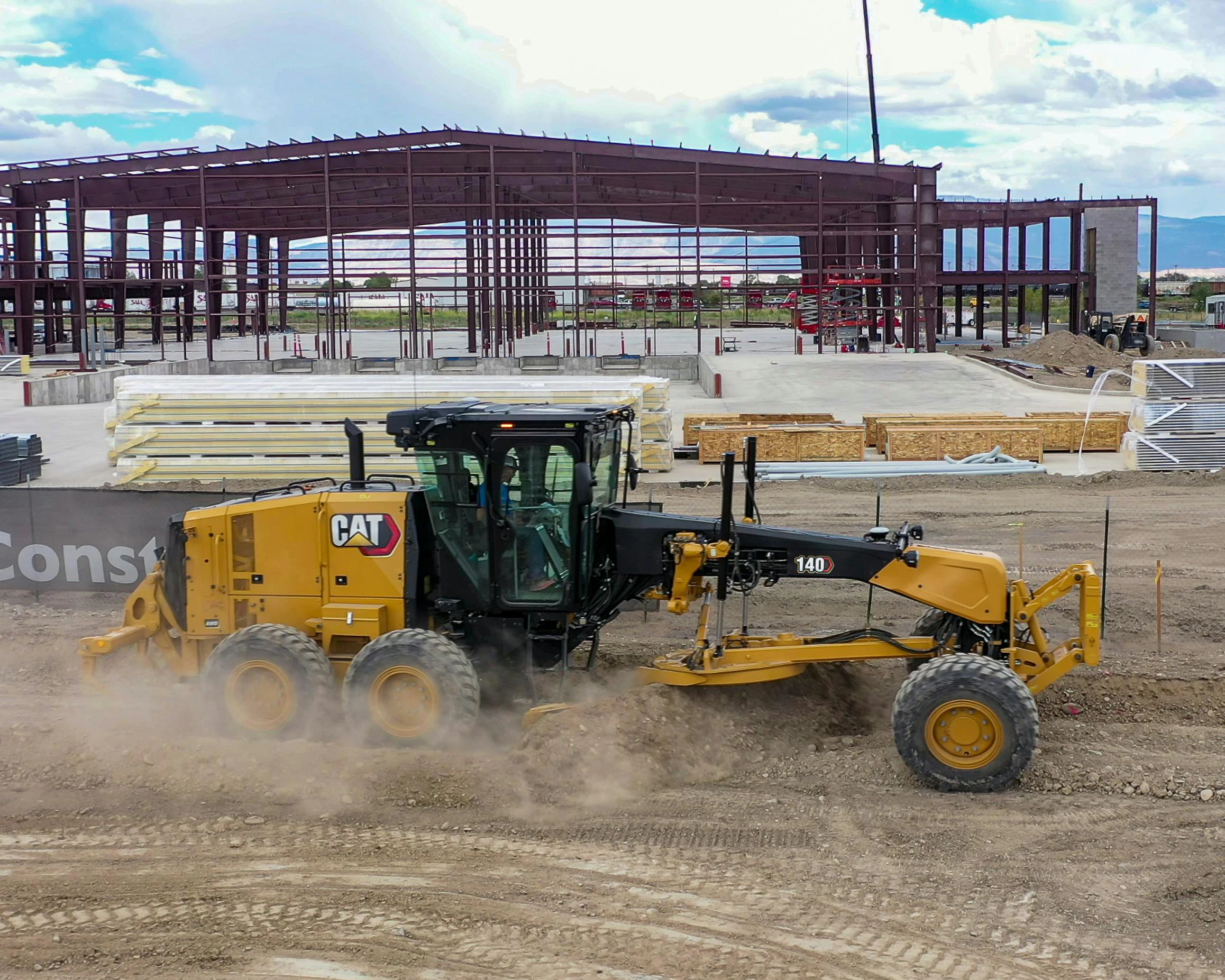 Caterpillar 140 motor grader grading dirt on a construction site