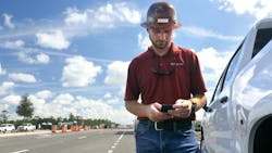 Fleetio’s 2026 Benchmark Report contractor on his phone walking out of his truck Fleetio’s 2026 Benchmark Report contractor on his phone walking out of his truck