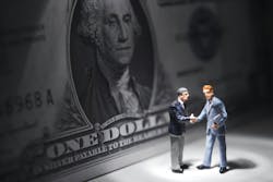 Shady business figures shaking hands in front an American dollar Shady business figures shaking hands in front an American dollar