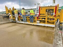 Gomaco Polymer Paver working on a project. Gomaco Polymer Paver working on a project.