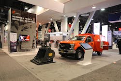 Tenna booth at a tradeshow with a bucket and a service truck Tenna booth at a tradeshow with a bucket and a service truck
