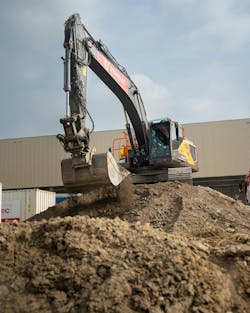 Topcon tech on a excavator as it dumps dirt Topcon tech on a excavator as it dumps dirt
