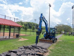 Blue Diamond breaker attachment on a blue mini excavator demoing a pathway Blue Diamond breaker attachment on a blue mini excavator demoing a pathway