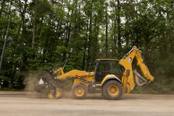 Caterpillar 450 backhoe loader using a broom attachment Caterpillar 450 backhoe loader using a broom attachment