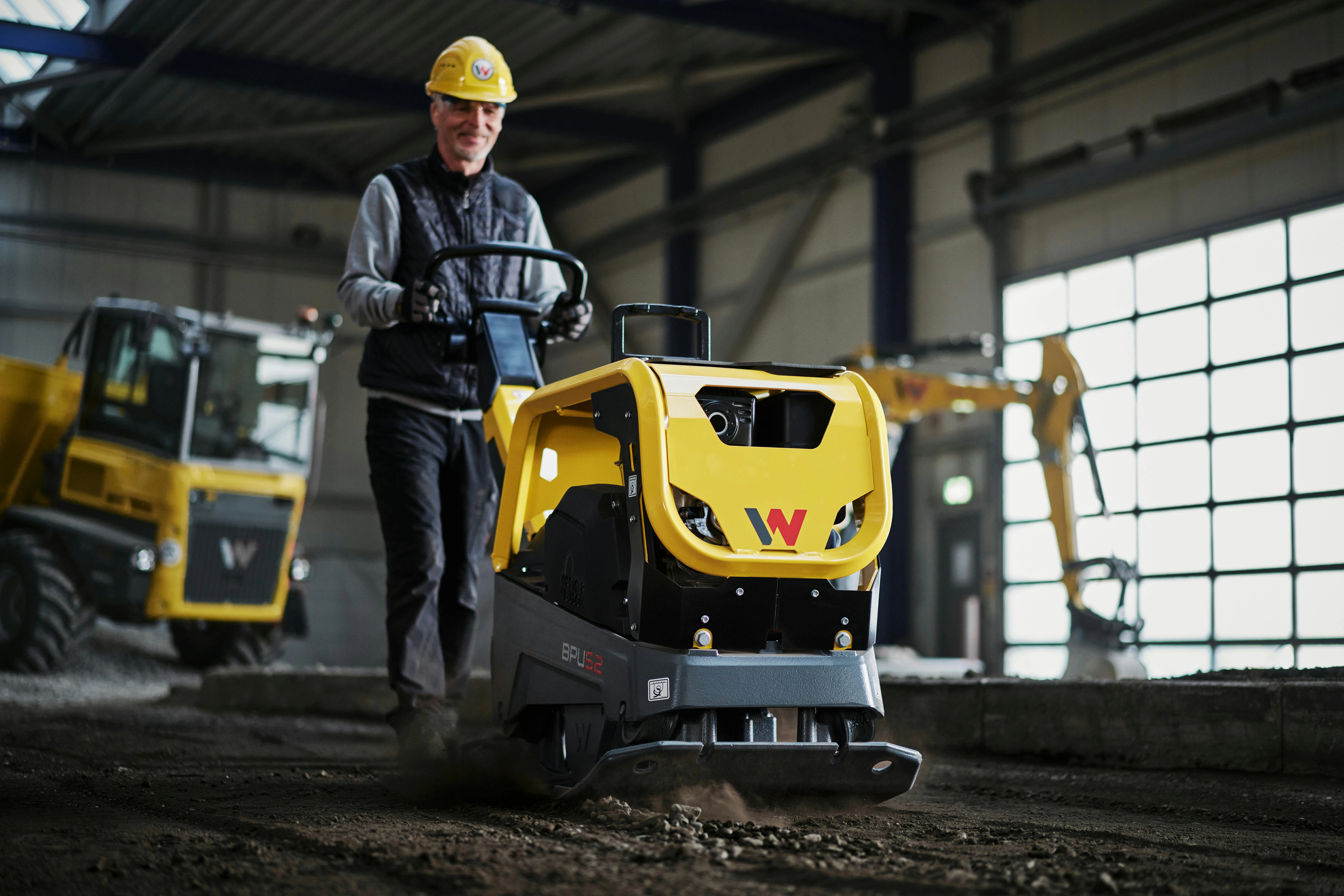Wacker Neuson DPU 52 compaction plate working on a soil