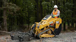 Cat mini track loader spreading mulch