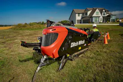 Ditch Witch JT21 horizontal directional drill in a field by a house. Ditch Witch JT21 horizontal directional drill in a field by a house.