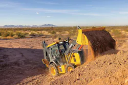 John Deere backhoe loader dumping a bucket full of dirt John Deere backhoe loader dumping a bucket full of dirt