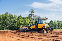 Hyundai HD130 Dozer pushing dirt with trees in the background. Hyundai HD130 Dozer pushing dirt with trees in the background.