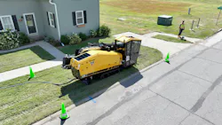 Vermeer D24 HDD Cab unit working by a house with a locator in the distance Vermeer D24 HDD Cab unit working by a house with a locator in the distance
