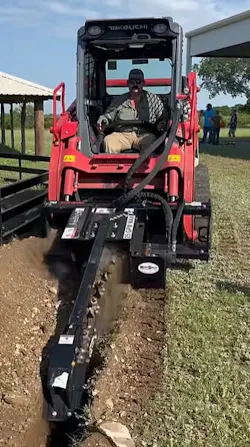Takeuchi trencher attachment digging in the dirt. Takeuchi trencher attachment digging in the dirt.