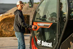 Bobcat tl623 telehandler, an operator opens the door. Bobcat tl623 telehandler, an operator opens the door.