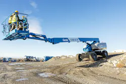 Genie S-85 XC FE hybrid boom lift with two workers. Genie S-85 XC FE hybrid boom lift with two workers.