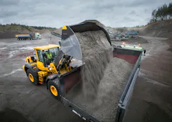 Volvo Construction Equipment wheel loader loading a dump truck. Volvo Construction Equipment wheel loader loading a dump truck.