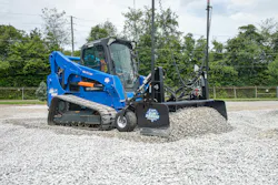 Blue Diamond Attachments land grader on a compact track loader pushing gravel. Blue Diamond Attachments land grader on a compact track loader pushing gravel.