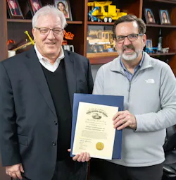 New Philadelphia Mayor Joel Day presents Mike Popovich, president of Gradall Industries, with a procolmation from the Ohio governor. New Philadelphia Mayor Joel Day presents Mike Popovich, president of Gradall Industries, with a procolmation from the Ohio governor.