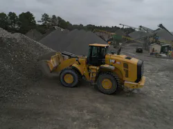 Caterpillar 980 wheel loader digging a dirt pile. Caterpillar 980 wheel loader digging a dirt pile.
