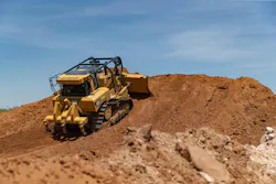 Cat dozer pushing dirt up a hill. Cat dozer pushing dirt up a hill.