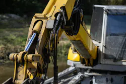 Excavator arm with a focus on hoses and cylinders. Excavator arm with a focus on hoses and cylinders.