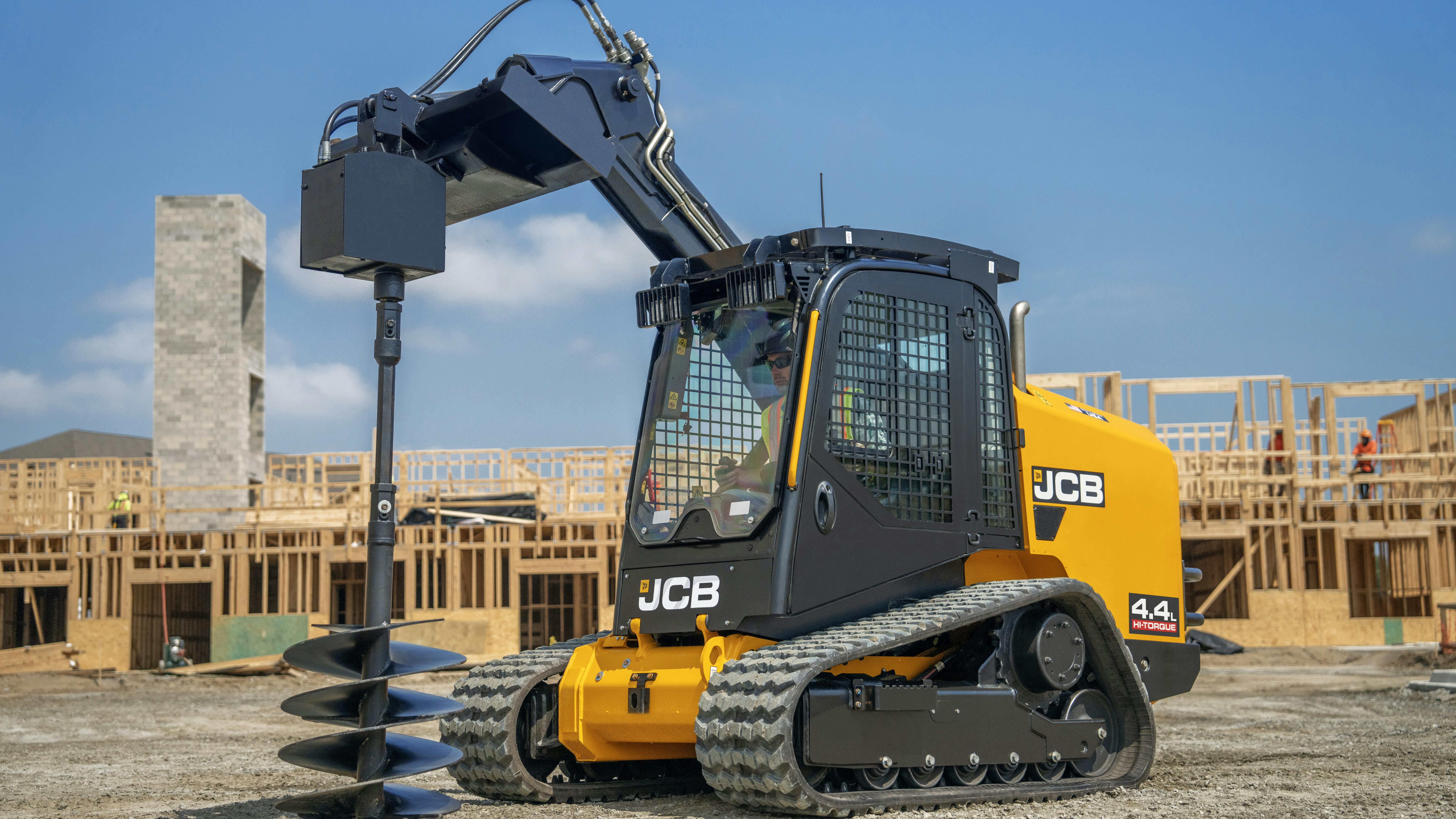 JCB compact track loader using an auger attachment.