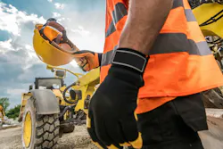 Hard Hat Construction Safety. Caucasian Heavy Duty Equipment Operator is About to Wear His Yellow Helmet Hard Hat Construction Safety. Caucasian Heavy Duty Equipment Operator is About to Wear His Yellow Helmet