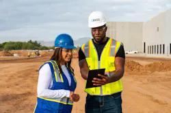 United Rentals worker showing customer work on a tablet. United Rentals worker showing customer work on a tablet.