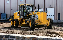 John Deere SmartGrade P-Tier grader rolling over dirt. John Deere SmartGrade P-Tier grader rolling over dirt.