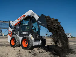 Ignite Bucket attachment on a Bobcat skid steer. It's dumping dirt. Ignite Bucket attachment on a Bobcat skid steer. It's dumping dirt.