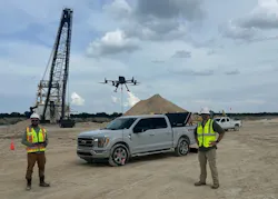 SPH Engineering drone team at a construction site. Drone flies in the air with a big crane in the background. SPH Engineering drone team at a construction site. Drone flies in the air with a big crane in the background.