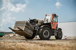 JLG 2733 telehandler carrying a set of wooden pallets. JLG 2733 telehandler carrying a set of wooden pallets.