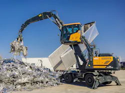 Hyundai HW250A MH material handler picking up scrap. Hyundai HW250A MH material handler picking up scrap.