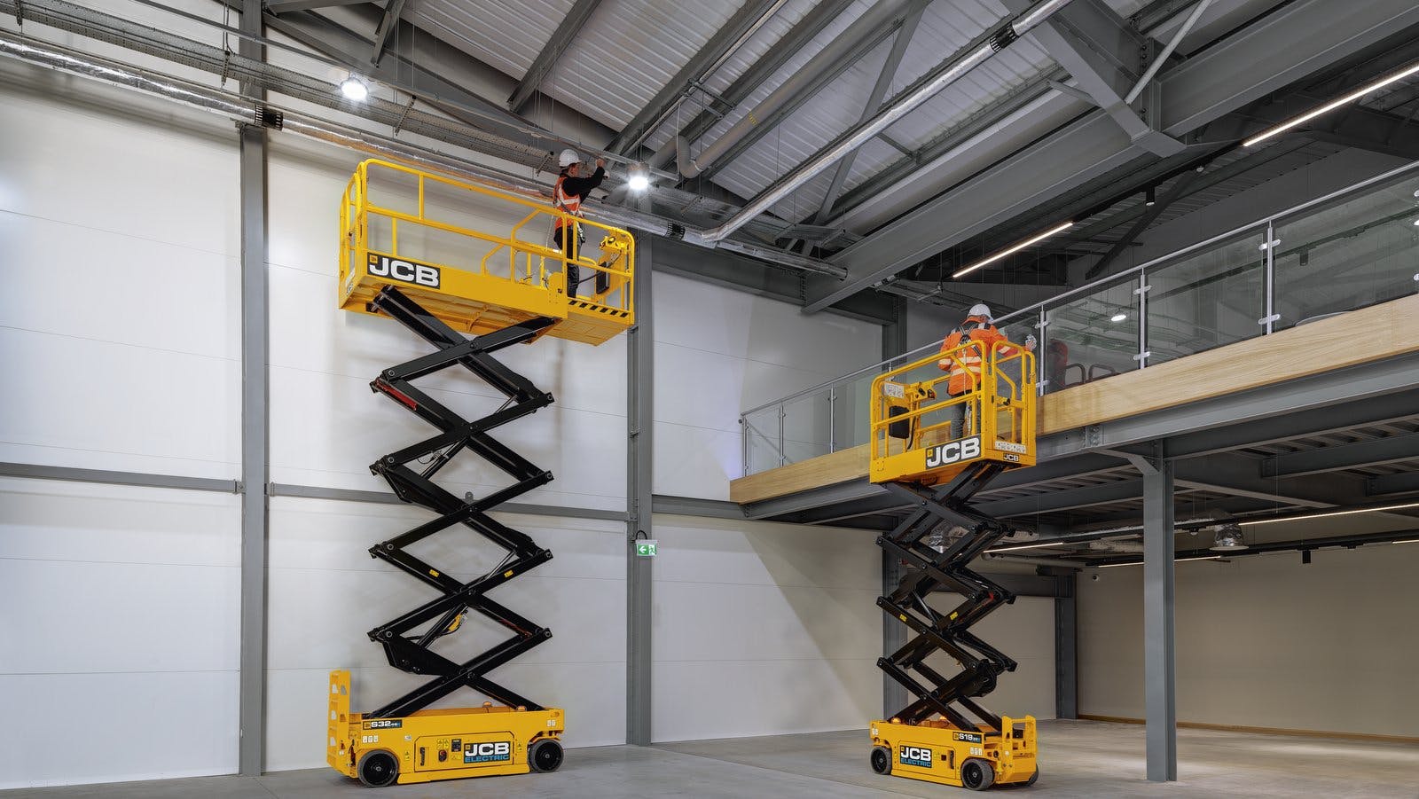 JCB S1932E Electric Scissor Lifts working inside a building.