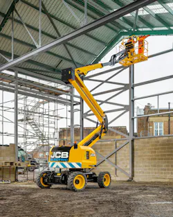 JCB electric boom lift lifting workers on a construction site. JCB electric boom lift lifting workers on a construction site.