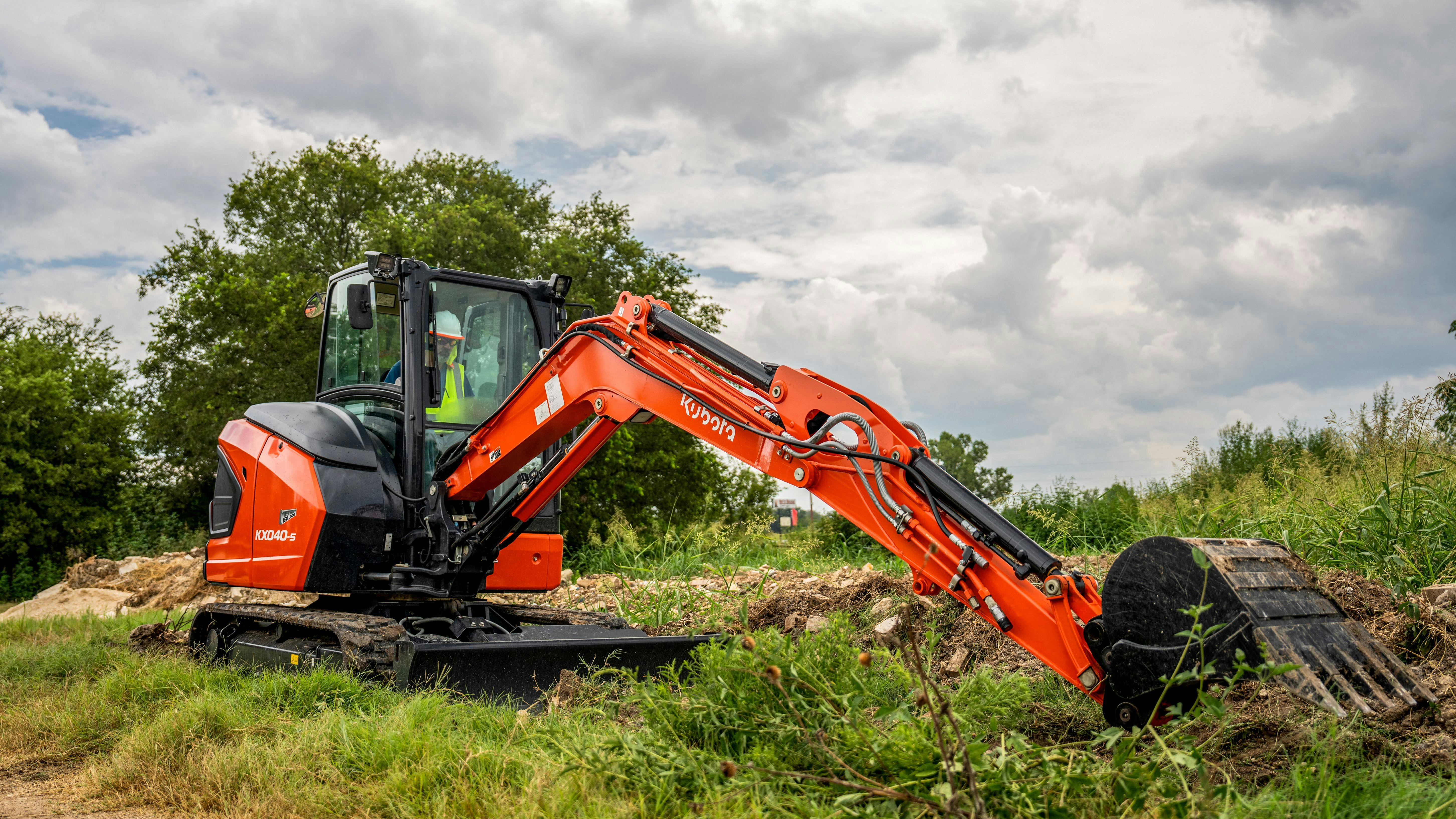 Kubota KX040-5 compact excavator reaching to full extension.