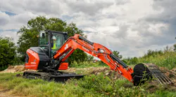Kubota KX040-5 compact excavator reaching to full extension.