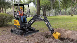 John Deere P-Tier 17 mini excavator digging a trench. John Deere P-Tier 17 mini excavator digging a trench.