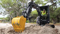 John Deere 26 P-Tier compact excavator with bucket in foreground. John Deere 26 P-Tier compact excavator with bucket in foreground.