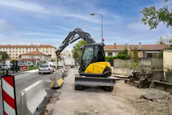 Mecalac MCR Series excavator carrying a jersey barrier. Mecalac MCR Series excavator carrying a jersey barrier.