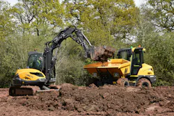 Mecalac MCR excavator dumping dirt into a dedicated dumper. Mecalac MCR excavator dumping dirt into a dedicated dumper.