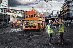 JLG ClearSky Smart Fleet telematics on JLG machines. Managers talk in the foreground. JLG ClearSky Smart Fleet telematics on JLG machines. Managers talk in the foreground.