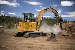 Caterpillar 305 CR compact excavator using a breaker attachment.