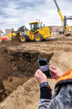 John Deere AI cameras. Man watching a camera on a phone. John Deere AI cameras. Man watching a camera on a phone.