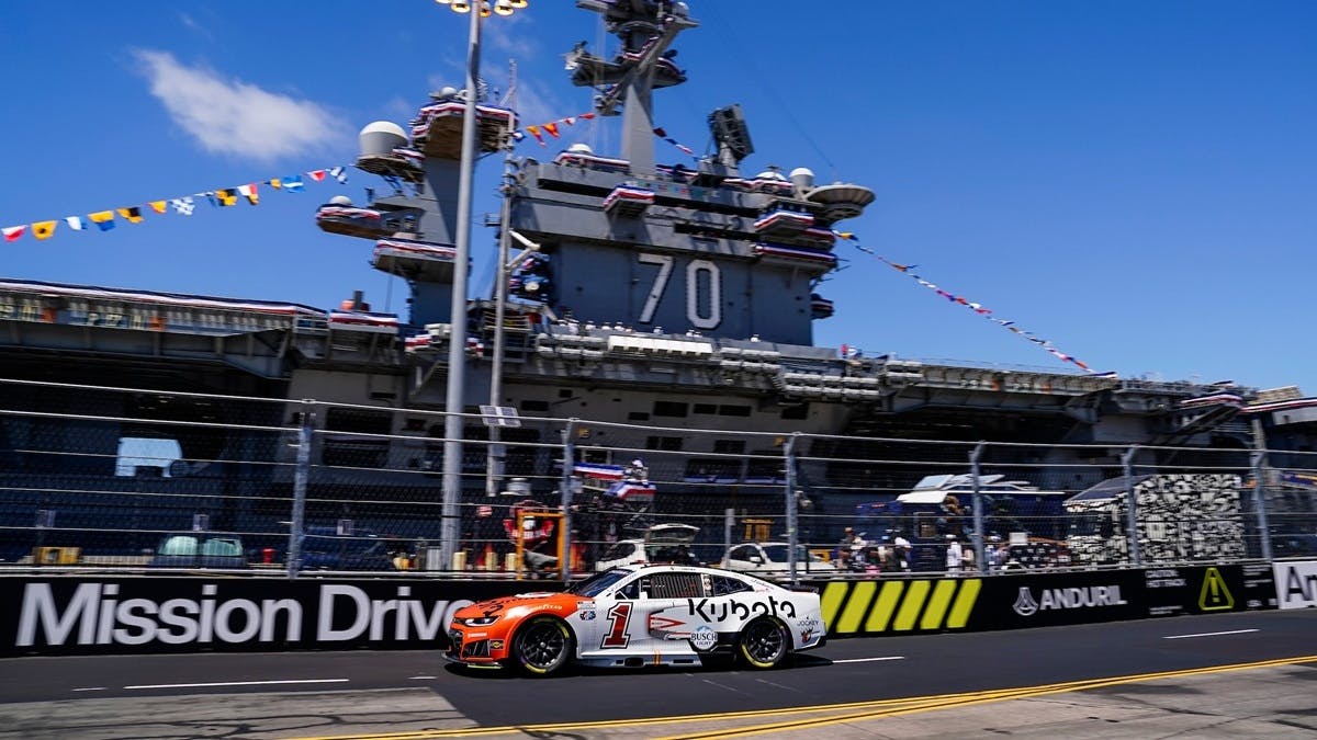 Trackhouse Racing's Ross Chastain drives the #1 Kubota Chevrolet in front of the USS Carl Vinson during the Anduril 250 at Naval Base Coronado on Sunday.