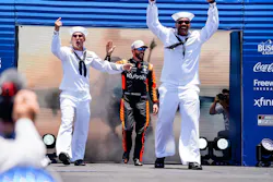 Trackhouse Racing's Ross Chastain walks out with two U.S. Navy Sailors during driver introductions before the Anduril 250 at Naval Base Coronado on Sunday.