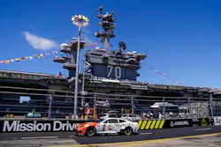 Trackhouse Racing's Ross Chastain drives the #1 Kubota Chevrolet in front of the USS Carl Vinson during the Anduril 250 at Naval Base Coronado on Sunday.
