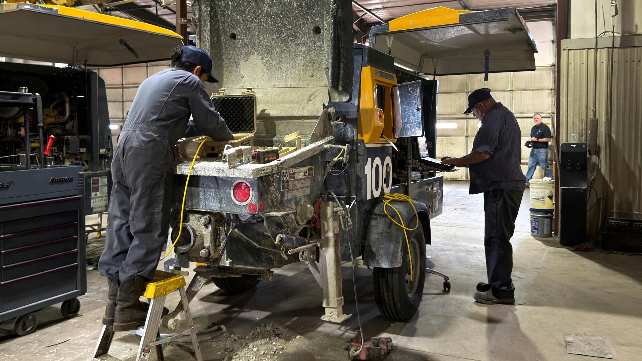 Techs perform service in a shop